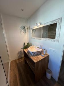 a bathroom with a sink and a mirror at Apartament BOHO in Częstochowa