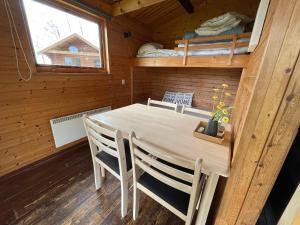 a dining room with a table and chairs in a cabin at Himmerland camping & Feriecenter in Års