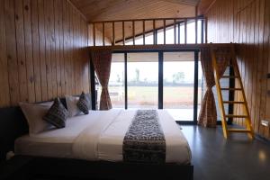 a bedroom with a large bed with a ladder at Shreephal luxurious Resort- Best resort in saputara in Saputara