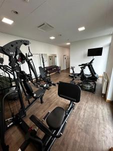 a gym with several tread machines in a room at Coffee Fellows Hotel München-Freiham in Munich