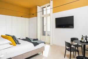 A bed or beds in a room at Loggiato Verga Luxury by Bed&Bros