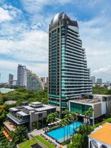 un edificio alto con una piscina di fronte di Cape Dara Resort - SHA Plus a Pattaya North