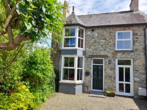 a stone house with white windows and a door at Uplands Newport, Pembrokeshire in Newport Pembrokeshire +13 photos