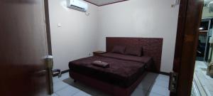 a bedroom with a bed with a suitcase on it at New Arcadia Residence in Jakarta