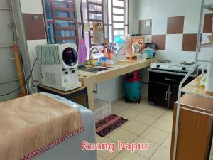 a kitchen with a sink and a counter top at FJ Homestay in Seri Iskandar