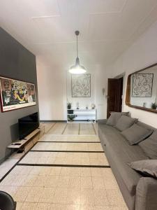 a living room with a couch and a television at Maison San Lorenzo Roma in Rome