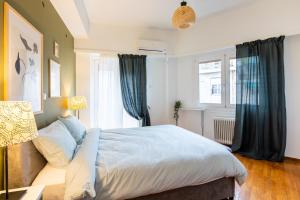 a bedroom with a large bed and a window at Feels like home apartment next to Acropolis in Athens