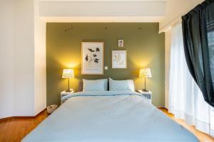 a bedroom with a large bed with two lamps at Feels like home apartment next to Acropolis in Athens