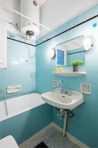 a blue bathroom with a sink and a tub at Feels like home apartment next to Acropolis in Athens