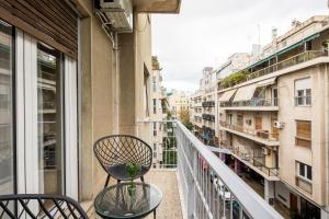 a balcony with a table and chairs on a balcony at Feels like home apartment next to Acropolis in Athens +27 photos