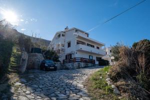 a house on the side of a road at Barba Damir in Pag