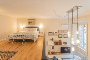 a bedroom with a bed and a tv in it at Cinque Giornate 70 Suites by Rent All Como in Como