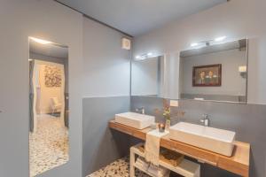 a bathroom with two sinks and a mirror at Cinque Giornate 70 Suites by Rent All Como in Como +132 photos