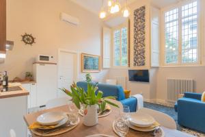 a kitchen and living room with a table and chairs at Cinque Giornate 70 Suites by Rent All Como in Como