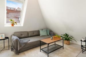a living room with a couch and a table at Dinbnb Apartments I 100 meters from Bryggen I Self check-in I Coffee + in Bergen