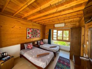 a room with two beds and a window at Club Red Dahab Motel in Dahab +132 photos