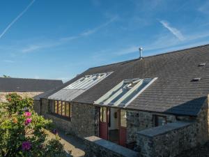 a house with a roof with solar panels on it at Treseissyllt Hafod St Nicholas in Saint Nicholas