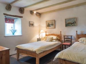 a bedroom with two beds and a window at Treseissyllt Hafod St Nicholas in Saint Nicholas