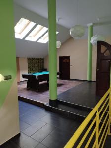 a pool table in a room with green columns at Willa Wiekowa Sosna in Zalesie Górne