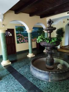 a fountain in the middle of a room at Willa Wiekowa Sosna in Zalesie Górne