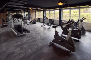 a gym with treadmills and exercise bikes in a room at Van der Valk Landhotel Spornitz in Spornitz