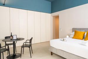 A bed or beds in a room at Loggiato Verga Luxury by Bed&Bros
