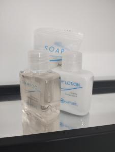 three bottles of soap sitting on top of a table at Onmood Roma Norte by HiHab New Opening 2024 in Mexico City