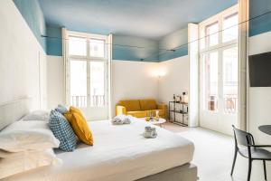 A bed or beds in a room at Loggiato Verga Luxury by Bed&Bros