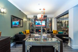 a living room with a table and couches at Croft Court Hotel in London