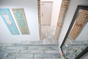 a stairway with mosaics on the walls and a door at Apartments Blue Ivy in Zadar +109 photos