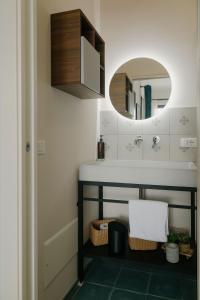 a bathroom with a sink and a mirror at La Bella Vita Lecce in Lecce