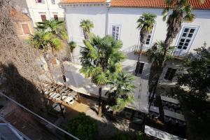 an overhead view of a white building with palm trees at Apartments Blue Ivy in Zadar