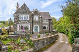 an old stone house with a stone driveway at Number One in Windermere