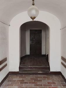 a hallway with a door and a brick floor at Dimora Storica in Petrignano