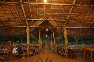 a wooden walkway in a restaurant with a large roof at Lake Resort Bolgoda in Wadduwa