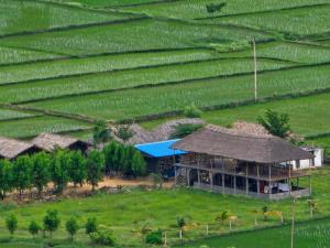 an aerial view of a house in the middle of a field at Hippie Land Nature Stay in Hampi