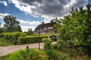 a large house with a sign in front of it at Gasterij de Heihorst in Someren