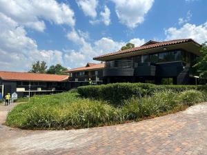 a building with a grassy area in front of it at BlackBrick Bedfordview in Johannesburg