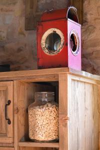 a red box sitting on top of a wooden cabinet with oats at Borgo Antichi Orti Assisi in Assisi