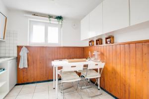 a kitchen with a white table and some chairs at Lotus Oasis I Nature Experience in Torre +52 photos