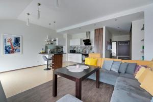 a living room with a couch and a table at Grand Apartments - Exclusive Beach Apartment in Gdańsk