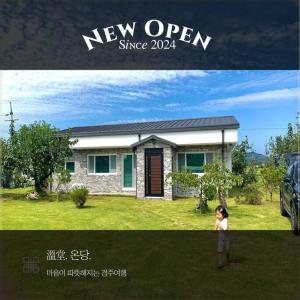 a woman standing in front of a house at On Dang in Gyeongju