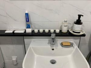 a bathroom with a sink and some bottles and cups at On Dang in Gyeongju