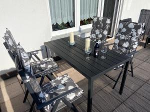 a table and two chairs with candles and wine glasses at Apartment - Wohnung bei Nürnberg #1 in Röthenbach an der Pegnitz