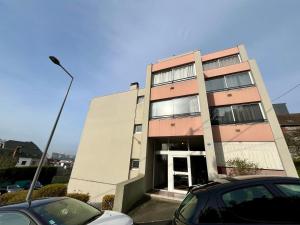 a tall building with cars parked in front of it at La balnéo de l'impératrice Anastasia - 306 in Rouen