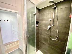 a shower with a glass door in a bathroom at Alla moda Milano P. Romana in Milan +24 photos