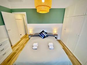 a bedroom with a large bed with two towels at Alla moda Milano P. Romana in Milan