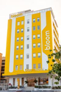a hotel with a large yellow and white building at Bloom Hotel - Ranchi in Rānchī