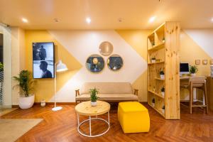 a living room with a couch and a table at Bloom Hotel - Ranchi in Rānchī