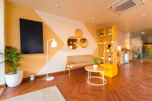 ein Wohnzimmer mit einem Sofa und einem Tisch in der Unterkunft Bloom Hotel - Ranchi in Ranchi